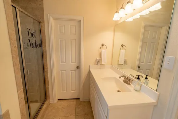 a bathroom with a tub sink and mirror
