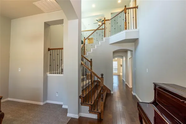 a view of entryway and hall with wooden floor