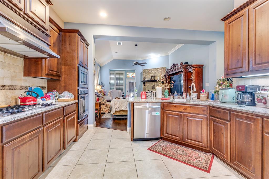 1036 Dunhill Lane Forney, TX 75126 - Photo 11 of 25 a kitchen with stainless steel appliances granite countertop a sink and cabinets