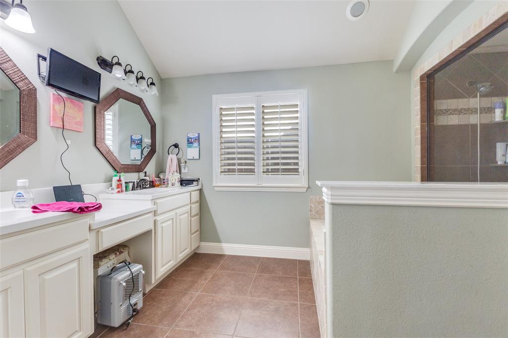 1036 Dunhill Lane Forney, TX 75126 - Photo 16 of 25 a bathroom with a sink and a mirror