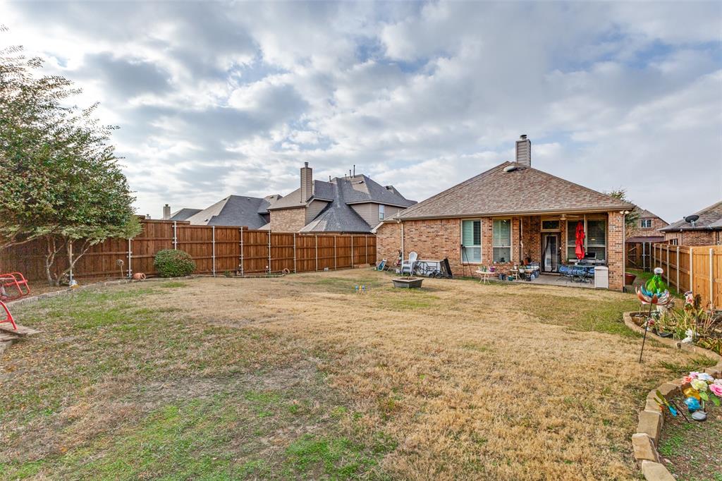 1036 Dunhill Lane Forney, TX 75126 - Photo 22 of 25 a front view of a house with garden