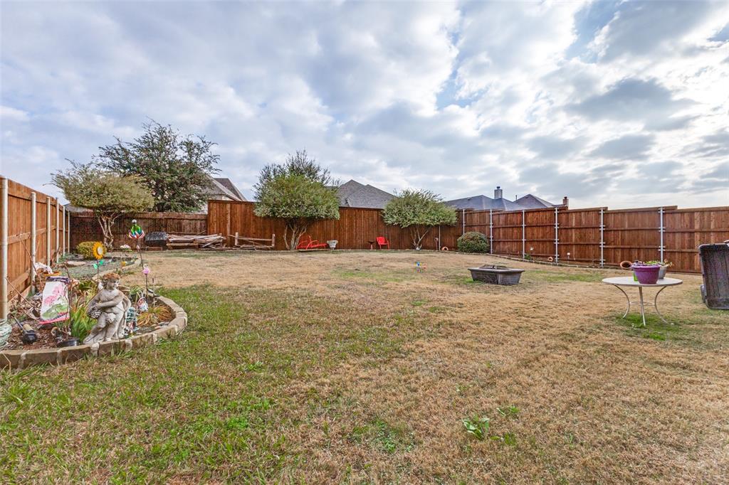 1036 Dunhill Lane Forney, TX 75126 - Photo 23 of 25 a view of a yard with table and chairs