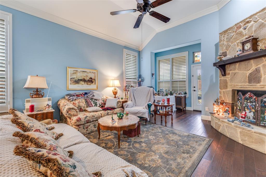 1036 Dunhill Lane Forney, TX 75126 - Photo 6 of 25 a living room with furniture and a fireplace