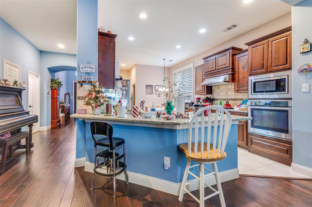 1036 Dunhill Lane Forney, TX 75126 - Photo 9 of 25 a view of a dining room with furniture and wooden floor