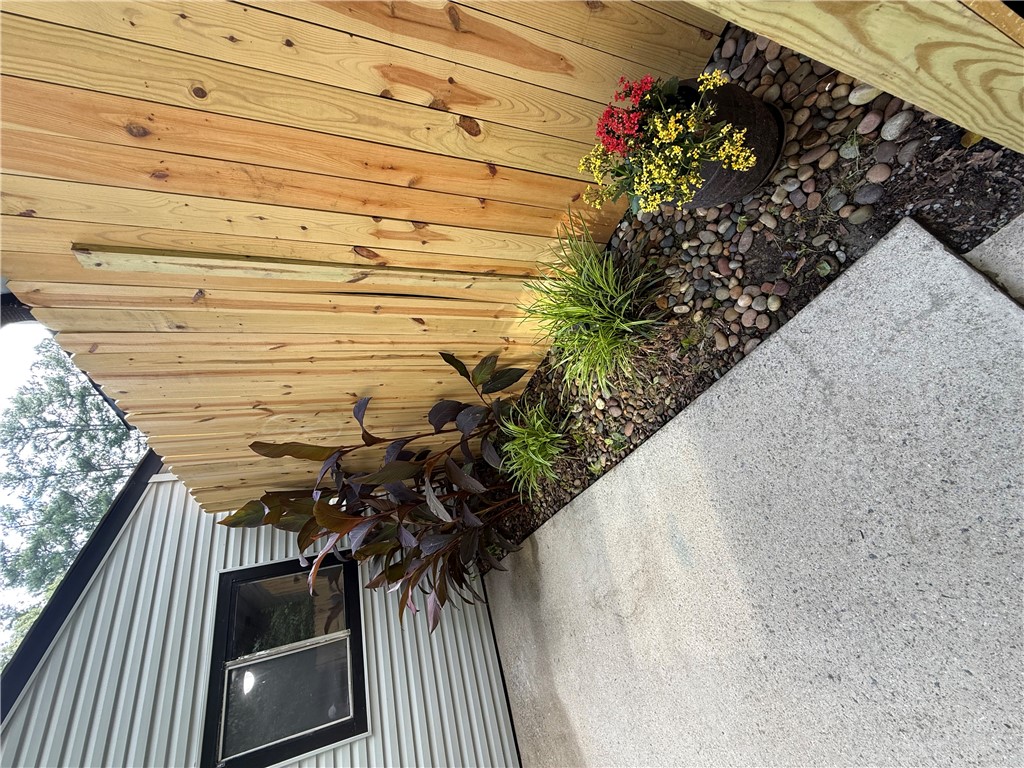 125 Maple Street, Unit 110 Pendleton, SC 29670 - Photo 4 of 18 A well-maintained patio features a newly installed wooden fence, a concrete path closeby, and neatly arranged landscaping.