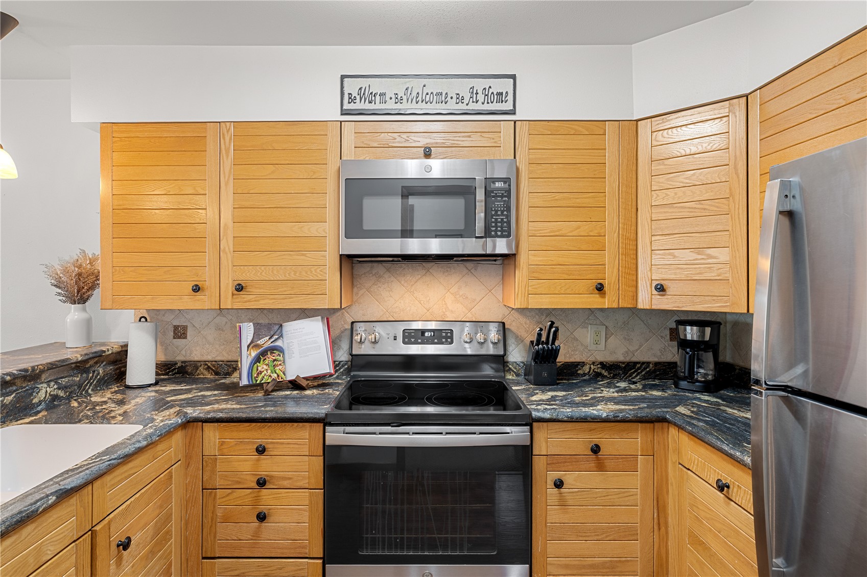 22804 Highway 6, Unit 102 Keystone, CO 80435 - Photo 10 of 34 a kitchen with granite countertop cabinets stainless steel appliances a sink and a window