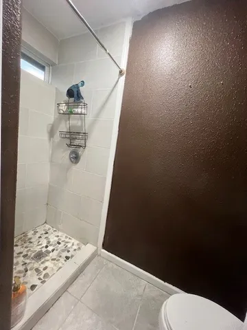 a bathroom with a toilet and shower