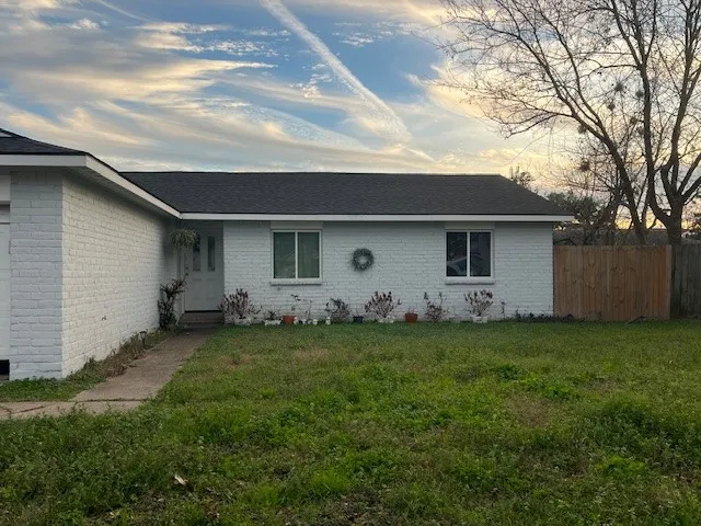 a front view of house with yard and trees