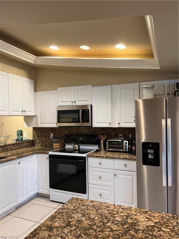 4060 Ice Castle Way, Unit 10 Naples, FL 34112 - Photo 3 of 15 a kitchen with stainless steel appliances granite countertop a stove a sink and a refrigerator