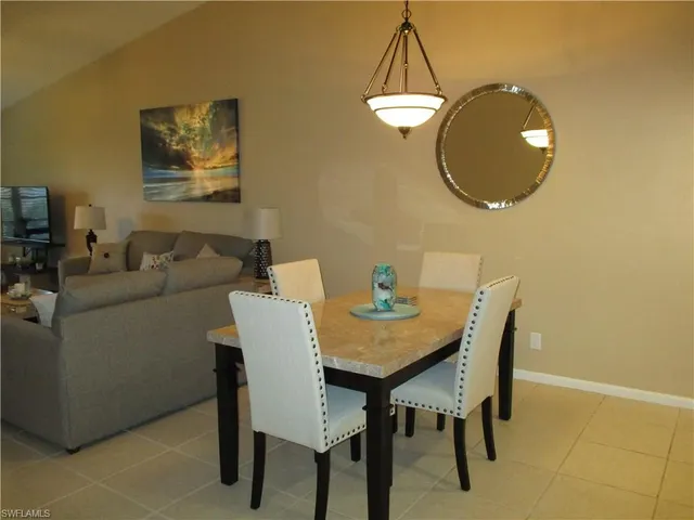a view of a dining room with furniture and a mirror