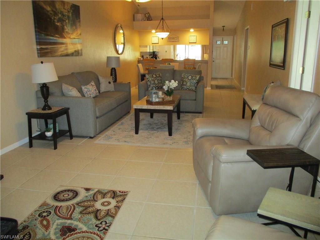 4060 Ice Castle Way, Unit 10 Naples, FL 34112 - Photo 6 of 15 a living room with furniture and a lamp