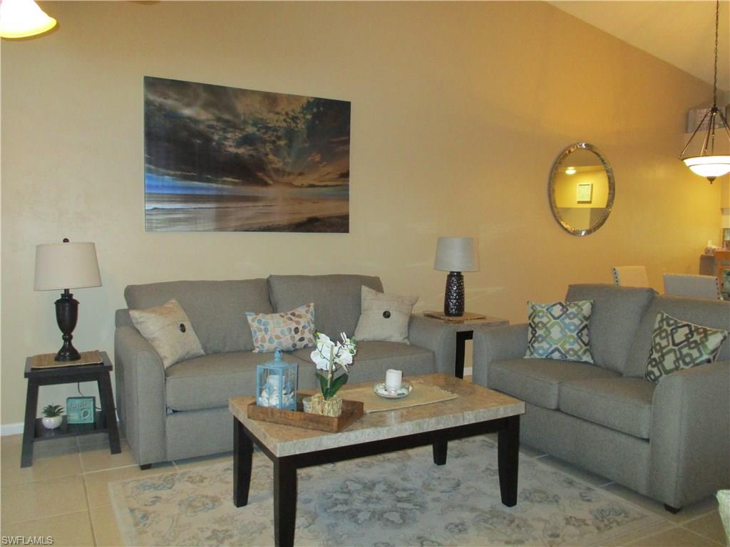 4060 Ice Castle Way, Unit 10 Naples, FL 34112 - Photo 7 of 15 a living room with furniture and a table