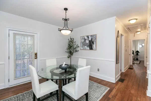 a dining room with furniture and wooden floor