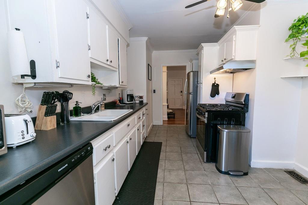 936 East Lake Drive Decatur, GA 30030 - Photo 15 of 50 a kitchen with granite countertop a sink counter top space appliances and cabinets