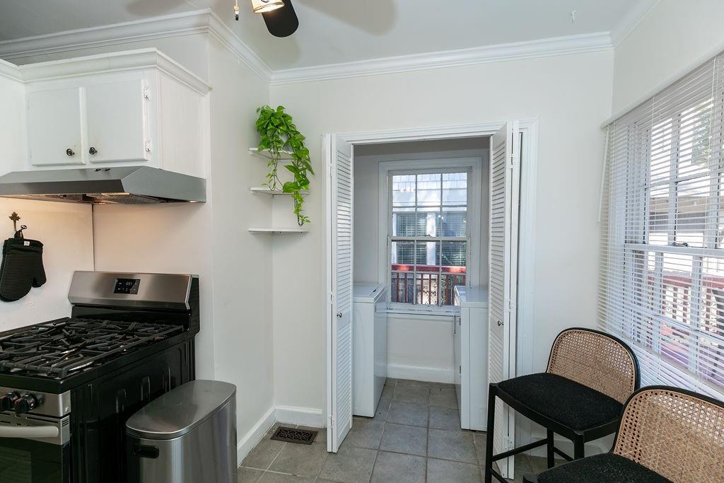 936 East Lake Drive Decatur, GA 30030 - Photo 16 of 50 a kitchen with stainless steel appliances granite countertop a stove a refrigerator and a dining table with wooden floor
