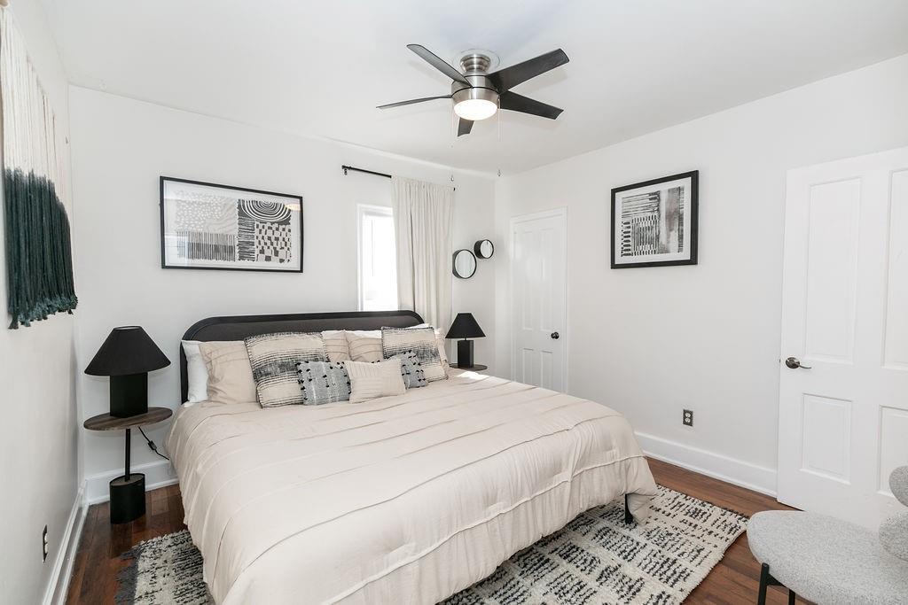 936 East Lake Drive Decatur, GA 30030 - Photo 19 of 50 a bedroom with a large bed and a lamp on a dresser
