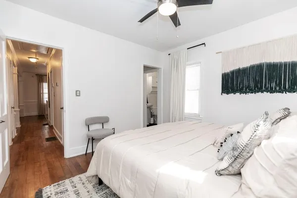 a bedroom with a bed and hallway