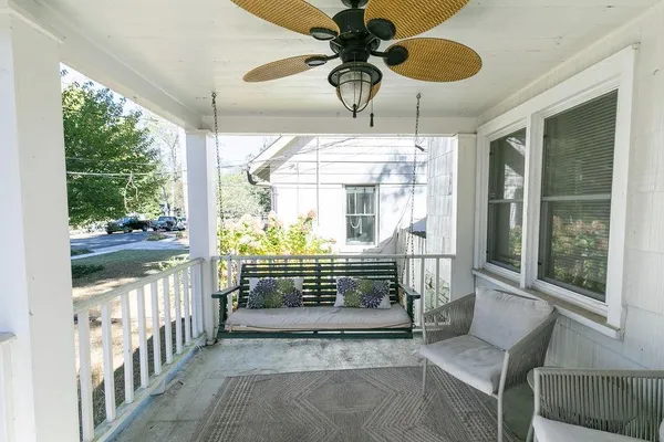 a living room with a ceiling fan furniture and a window