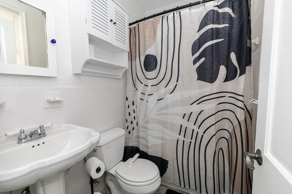 936 East Lake Drive Decatur, GA 30030 - Photo 22 of 50 a bathroom with a sink a toilet and a mirror