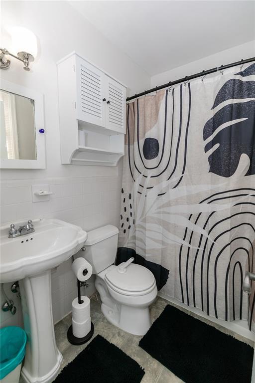 936 East Lake Drive Decatur, GA 30030 - Photo 23 of 50 a bathroom with a sink a toilet and a mirror