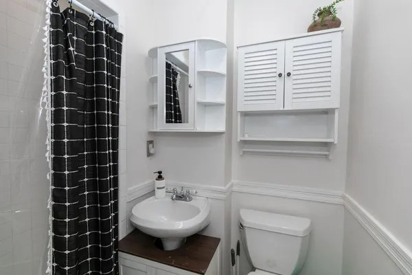 a bathroom with a sink toilet and shower
