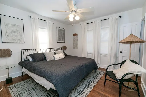 a bedroom with a bed and a chandelier