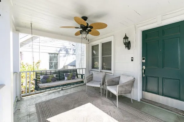 a outdoor living space with chairs and a rug