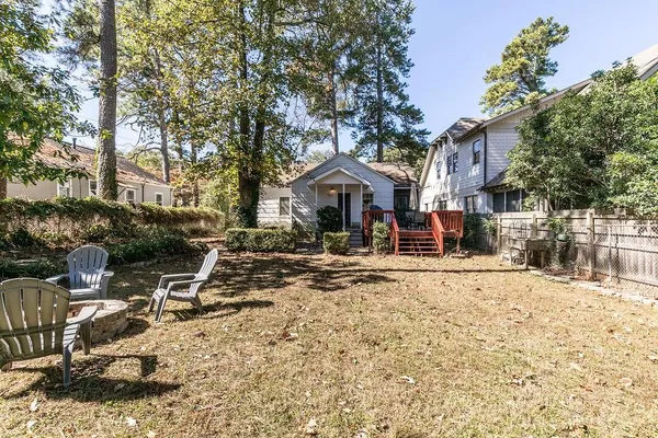 a view of a house with a yard chairs and refrigerator