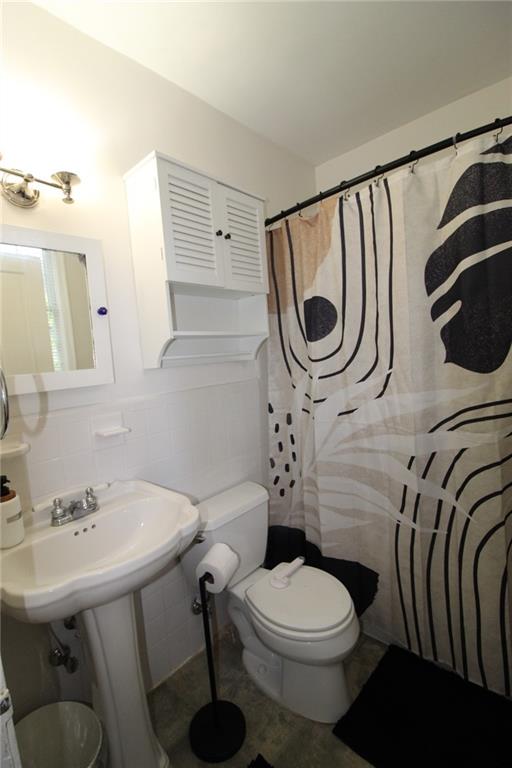 936 East Lake Drive Decatur, GA 30030 - Photo 41 of 50 a bathroom with a toilet a sink and mirror