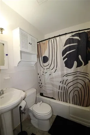 a bedroom with a bed and chair