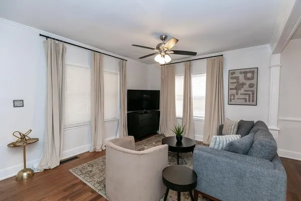 a living room with furniture and a fireplace