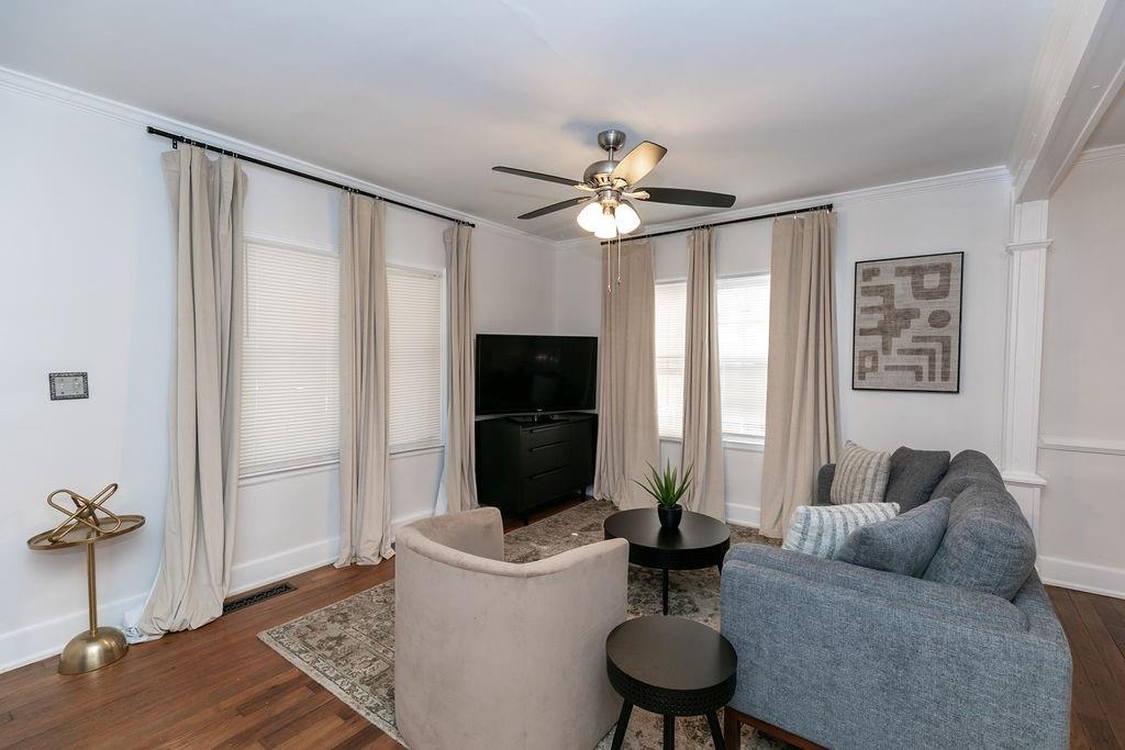 936 East Lake Drive Decatur, GA 30030 - Photo 6 of 50 a living room with furniture a flat screen tv and a table