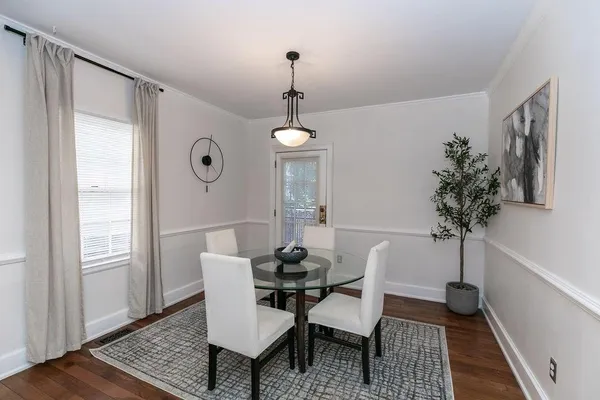 a view of a dining room with furniture and wooden floor