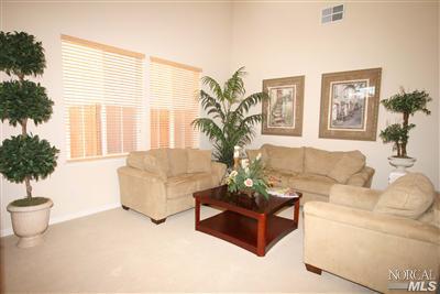 Make a memorable first impression to guests while entering home into this impressive living room area with soaring cathedral ceilings and an abundance of natural lighting.