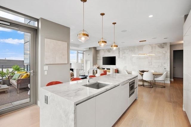 a view of kitchen island kitchen island sink stove and living room view