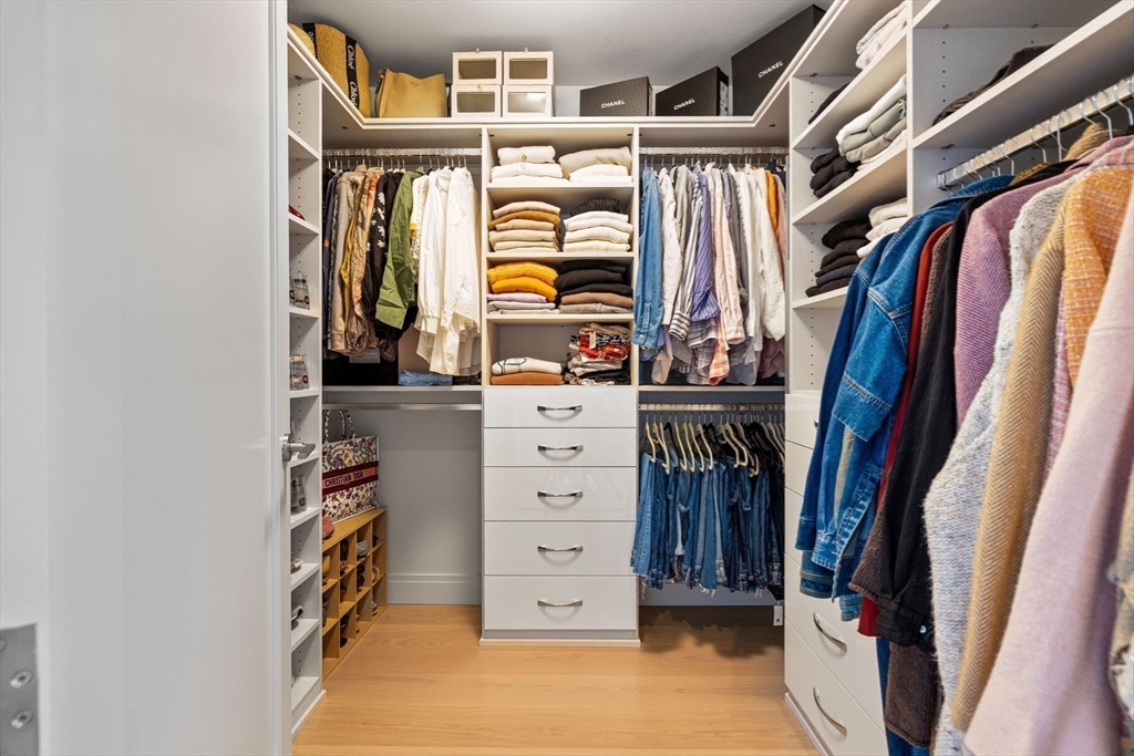 133 Seaport Boulevard, Unit PH 3A Boston, MA 02210 - Photo 19 of 25 a view of walk in closet with clothes and shoes