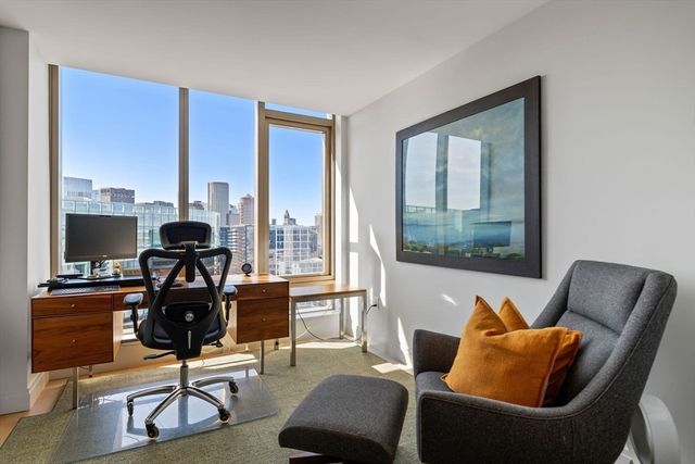 a living room with furniture and a floor to ceiling window