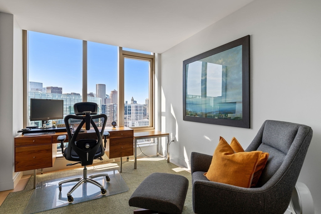 133 Seaport Boulevard, Unit PH 3A Boston, MA 02210 - Photo 21 of 25 a living room with furniture and a floor to ceiling window