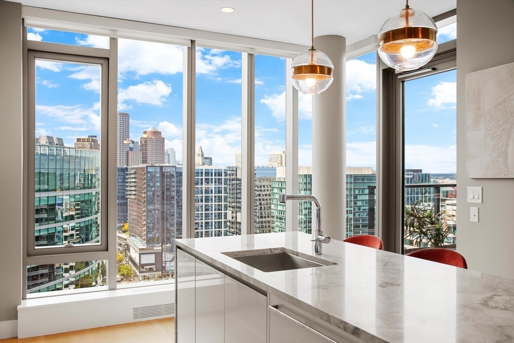 133 Seaport Boulevard, Unit PH 3A Boston, MA 02210 - Photo 7 of 25 a kitchen with a sink and a large window