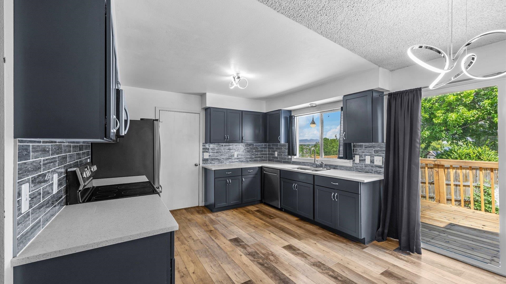 386 Ridge Cir Drive Grand Junction, CO 81507 - Photo 12 of 33 a kitchen with granite countertop a sink stove and refrigerator