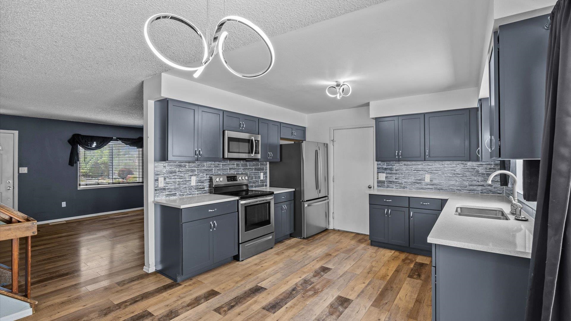 386 Ridge Cir Drive Grand Junction, CO 81507 - Photo 14 of 33 a kitchen with stainless steel appliances granite countertop a sink a stove and a refrigerator