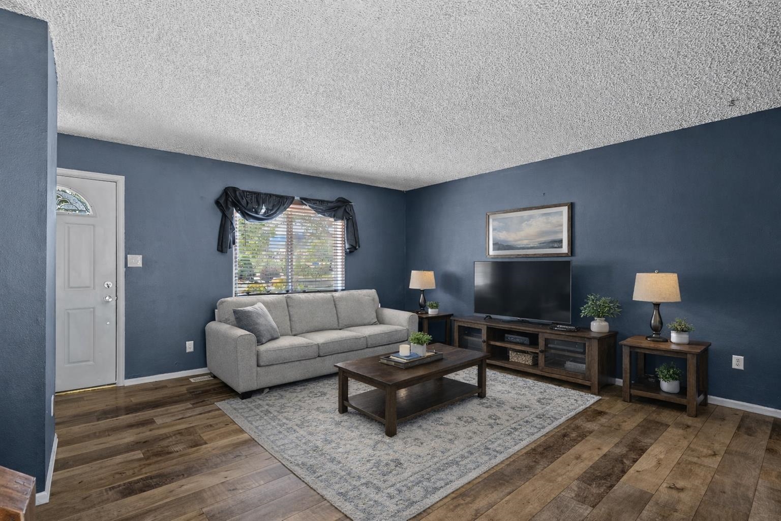 386 Ridge Cir Drive Grand Junction, CO 81507 - Photo 10 of 33 a living room with furniture a rug and a window