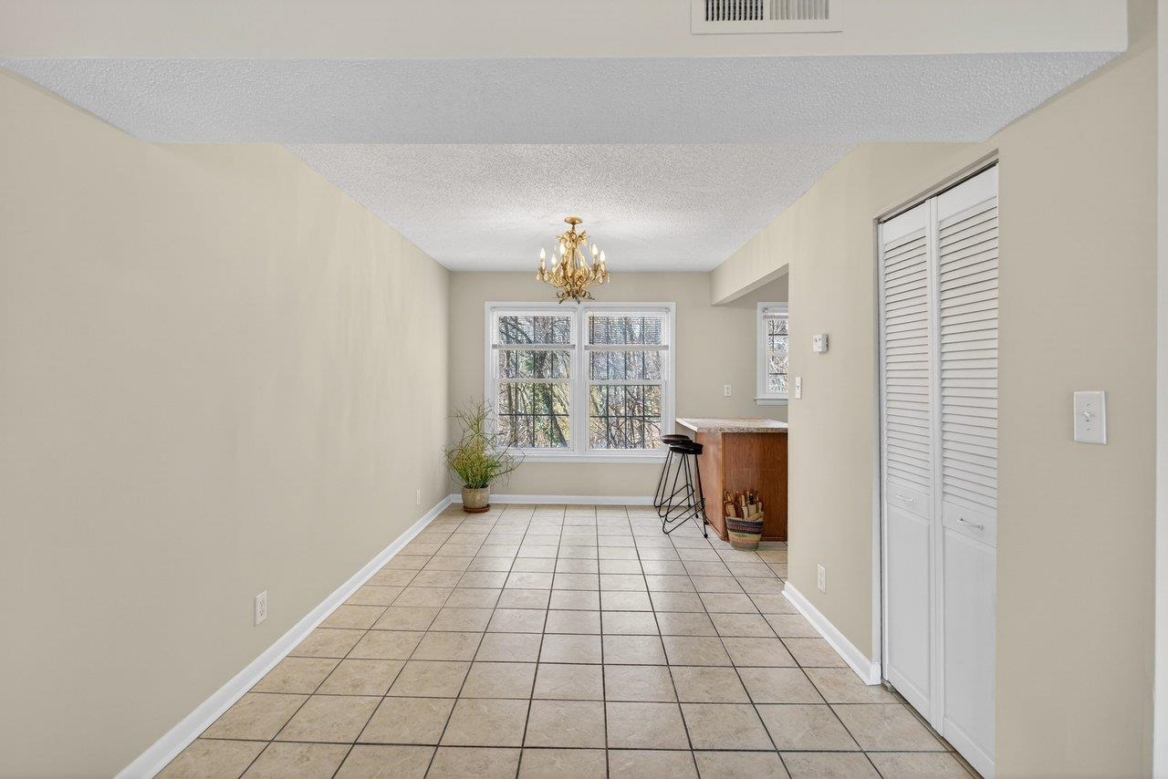 2527 Hydraulic Road, Unit 26 Charlottesville, VA 22901 - Photo 11 of 56 a view of empty room with windows
