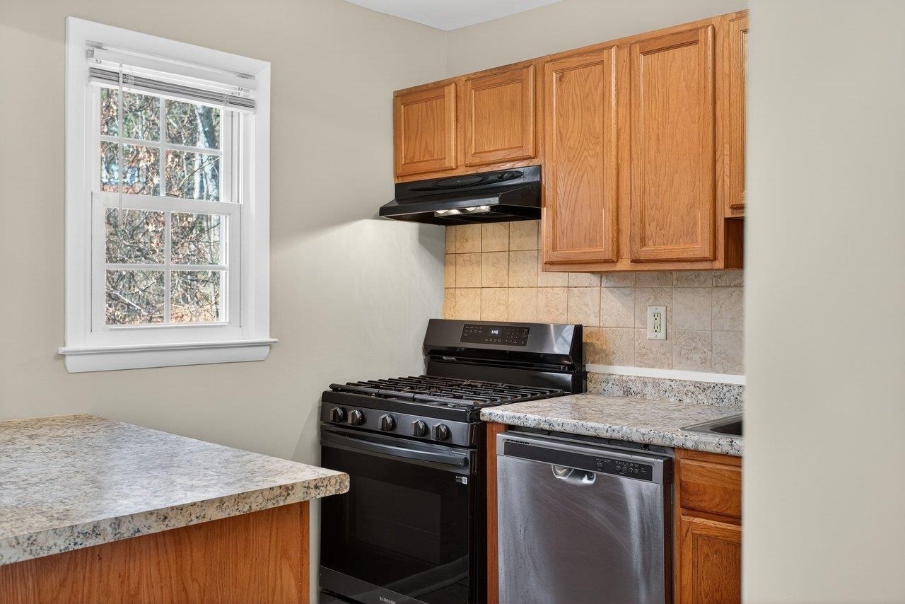 2527 Hydraulic Road, Unit 26 Charlottesville, VA 22901 - Photo 15 of 56 a kitchen with stainless steel appliances granite countertop a stove a sink and a microwave