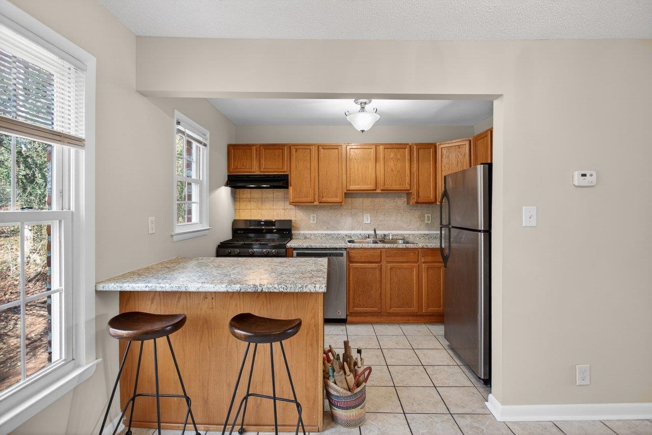 2527 Hydraulic Road, Unit 26 Charlottesville, VA 22901 - Photo 17 of 56 a kitchen with stainless steel appliances granite countertop a stove a sink and a refrigerator