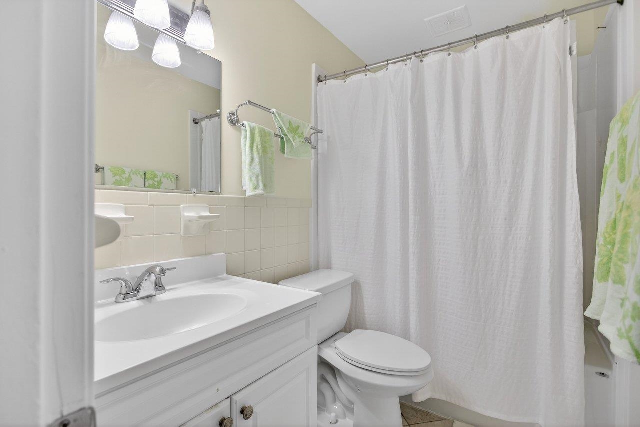 2527 Hydraulic Road, Unit 26 Charlottesville, VA 22901 - Photo 26 of 56 a bathroom with a sink a toilet and shower curtain