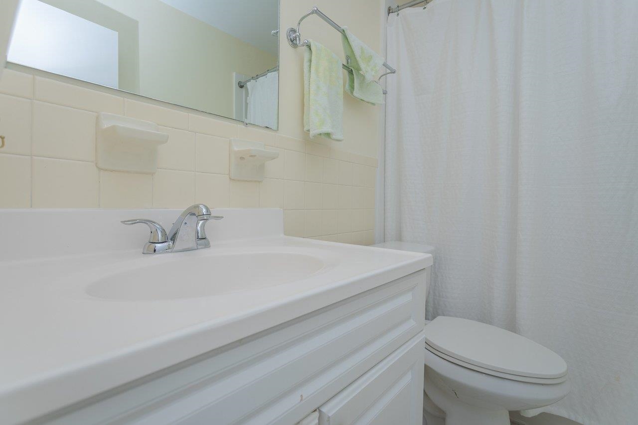 2527 Hydraulic Road, Unit 26 Charlottesville, VA 22901 - Photo 27 of 56 a bathroom with a sink a toilet and mirror