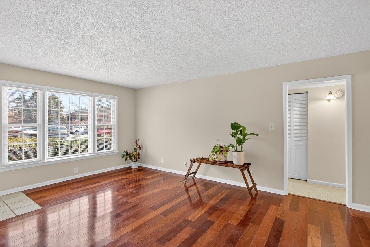 2527 Hydraulic Road, Unit 26 Charlottesville, VA 22901 - Photo 3 of 56 a living room with wooden floor and a table