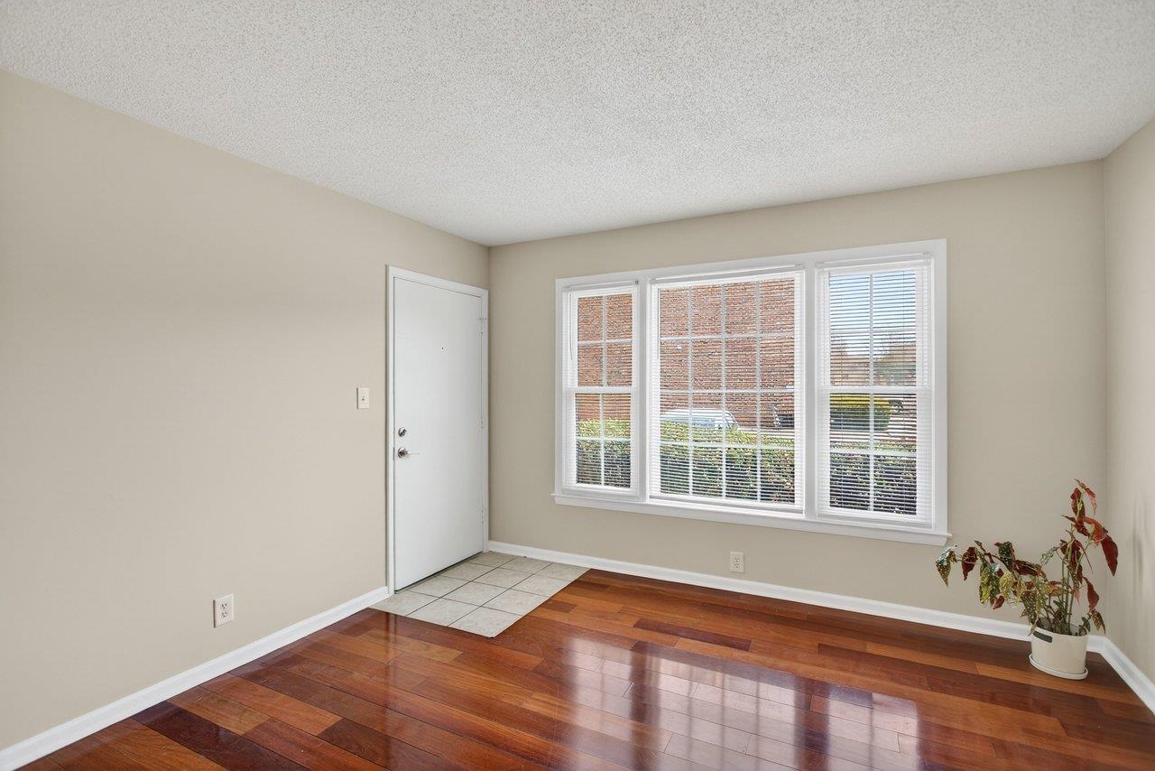 2527 Hydraulic Road, Unit 26 Charlottesville, VA 22901 - Photo 7 of 56 a view of an empty room with a window and wooden floor