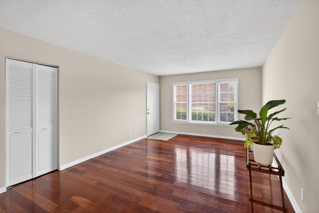 2527 Hydraulic Road, Unit 26 Charlottesville, VA 22901 - Photo 8 of 56 a view of empty room with wooden floor and potted plant